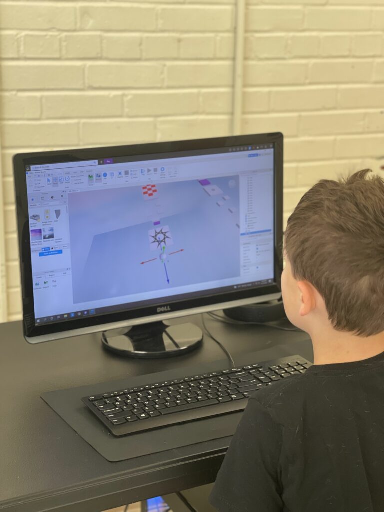 Boy on computer at STEM camp in Garner NC